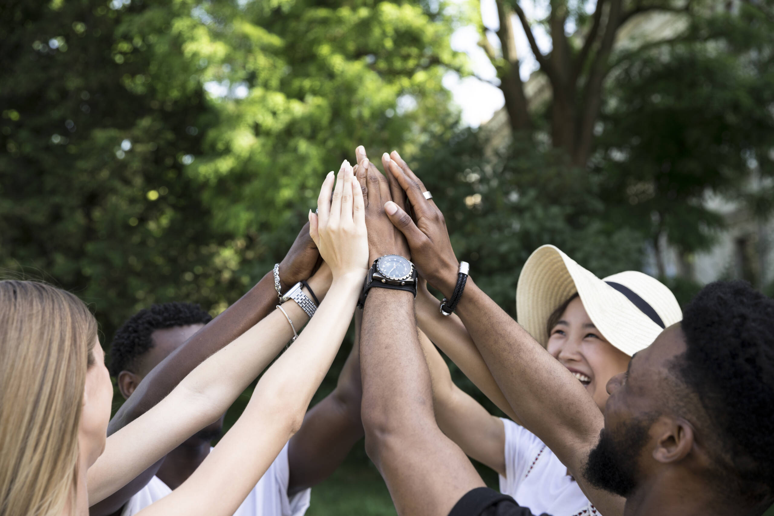 front-view-interracial-friends-cheering-scaled